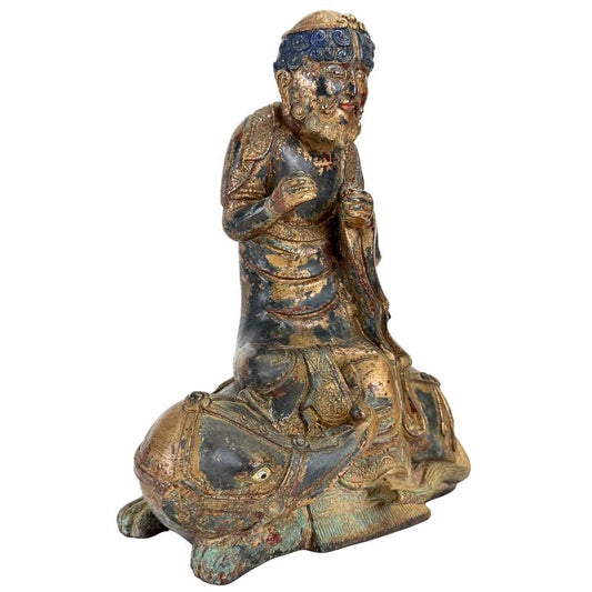 Arhat seated on Dano animal in bronze Himalayan statue