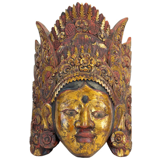 Detailed front view of the hand-carved Balinese dance mask of Dewi Sinta, showing the serene facial features and the refined, layered crown.