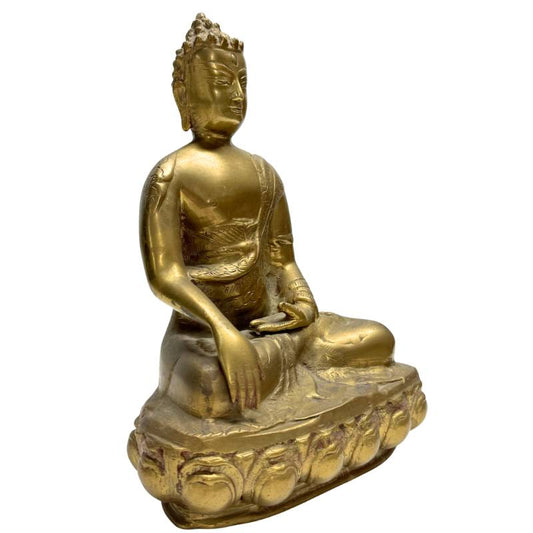 Oblique view of the Buddha statue focusing on the Bhumisparsha mudra and the depth of the bronze casting.