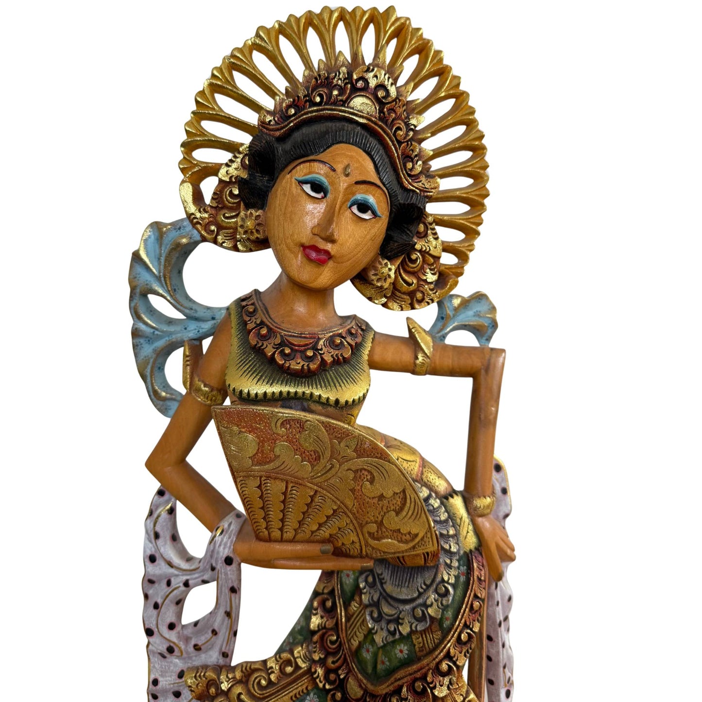 The serene facial features of the dancer, modeled after the celestial nymphs of Balinese mythology.