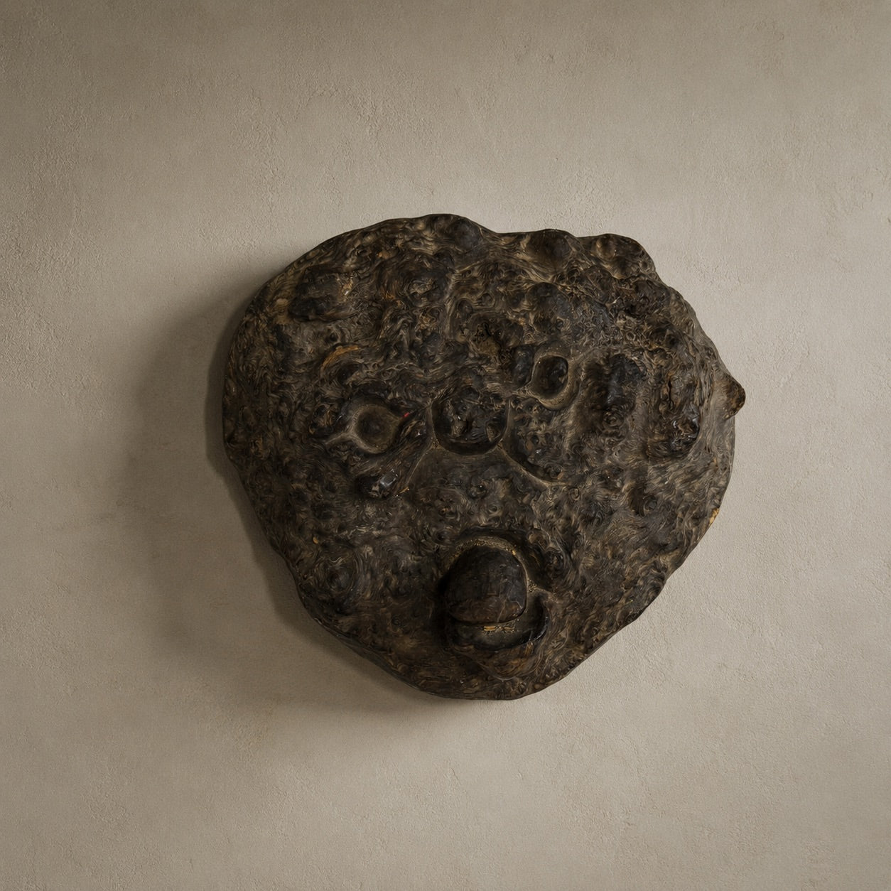 Hand-carved wooden mask from the Himalayan region, unique tribal wall object with abstract root wood structure