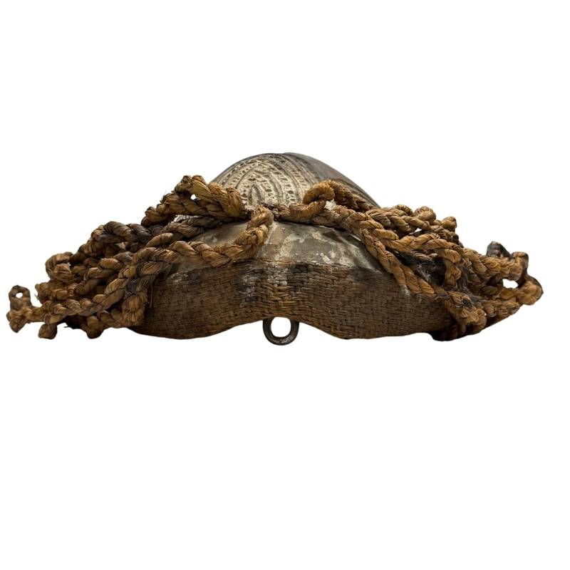 Wooden African mask with weathered white kaolin layer, dark headdress and visible signs of old use