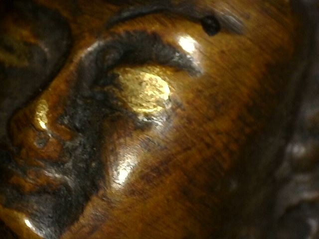 Microscope detail of gilding residue on an antique bronze Buddha with Dhyana Mudra