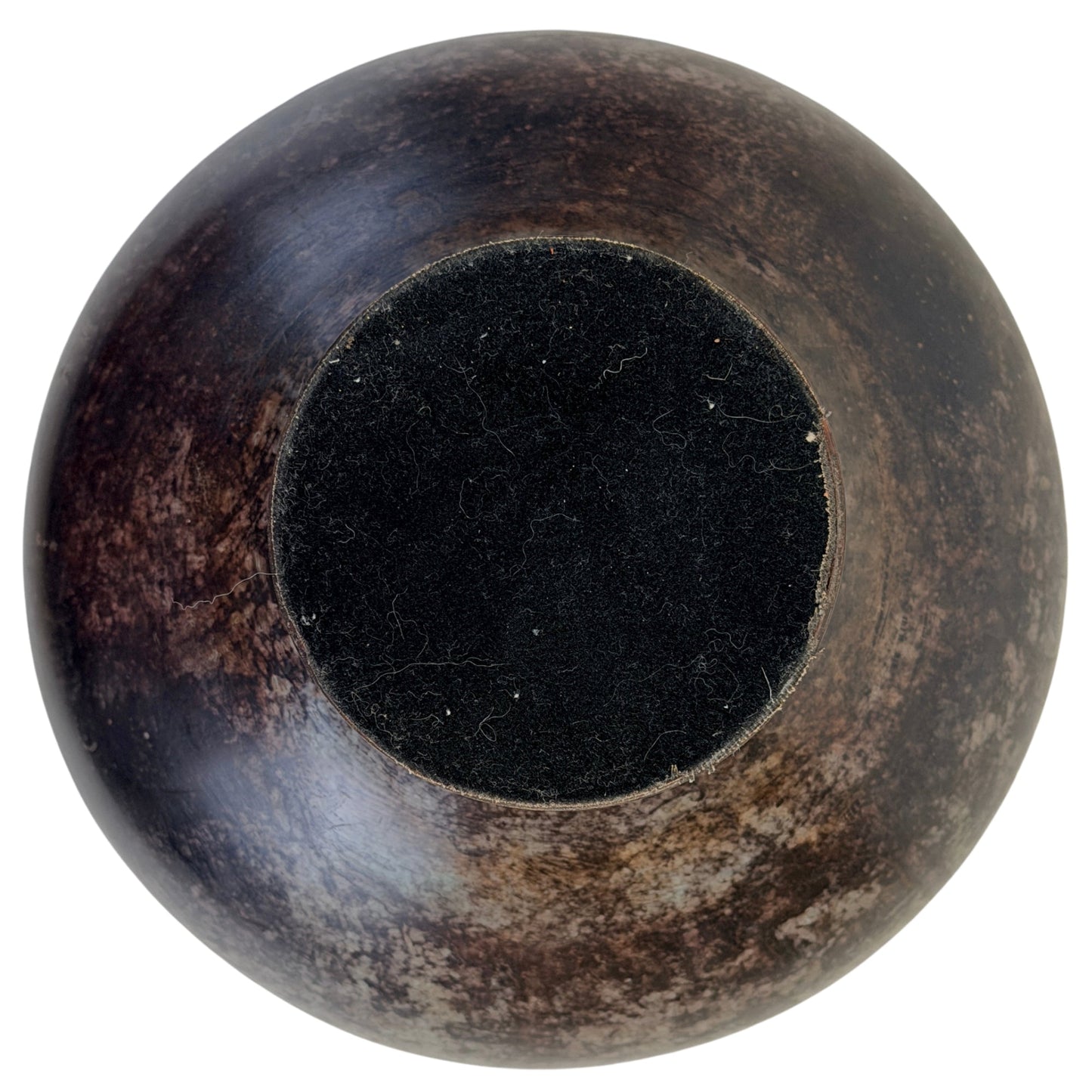 Underside of bronze vessel B with later black felt protection