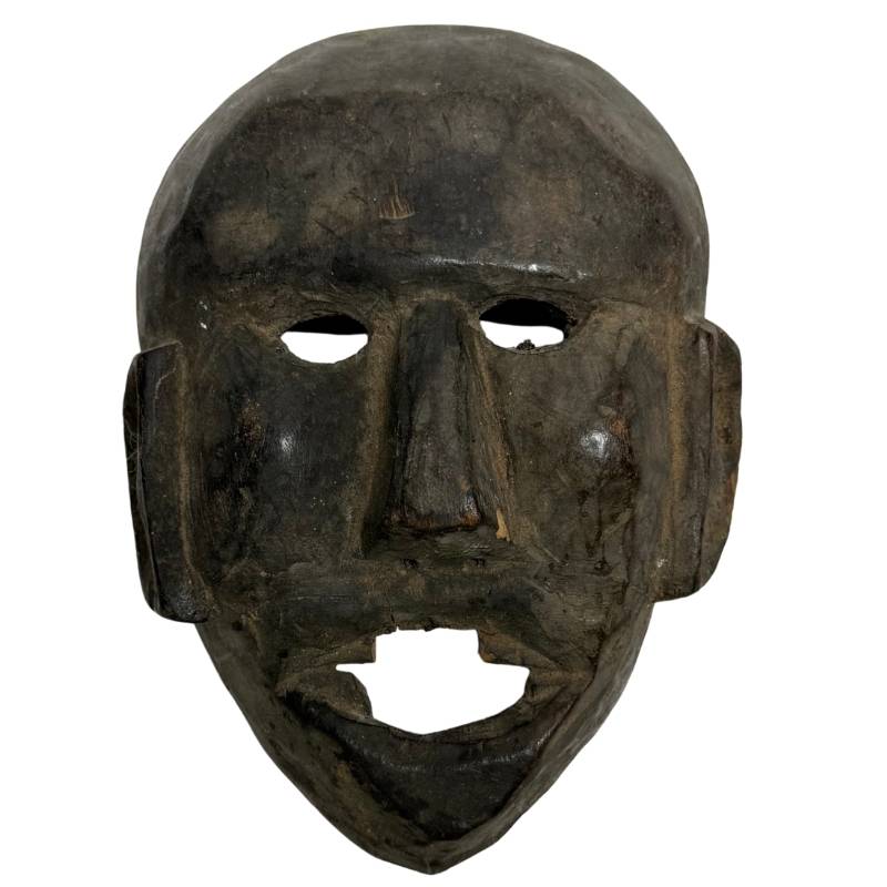 Primitive hand-carved antique wooden shaman mask from the Himalayas, 18.5 cm high, with deep black layered temple and soot patina.