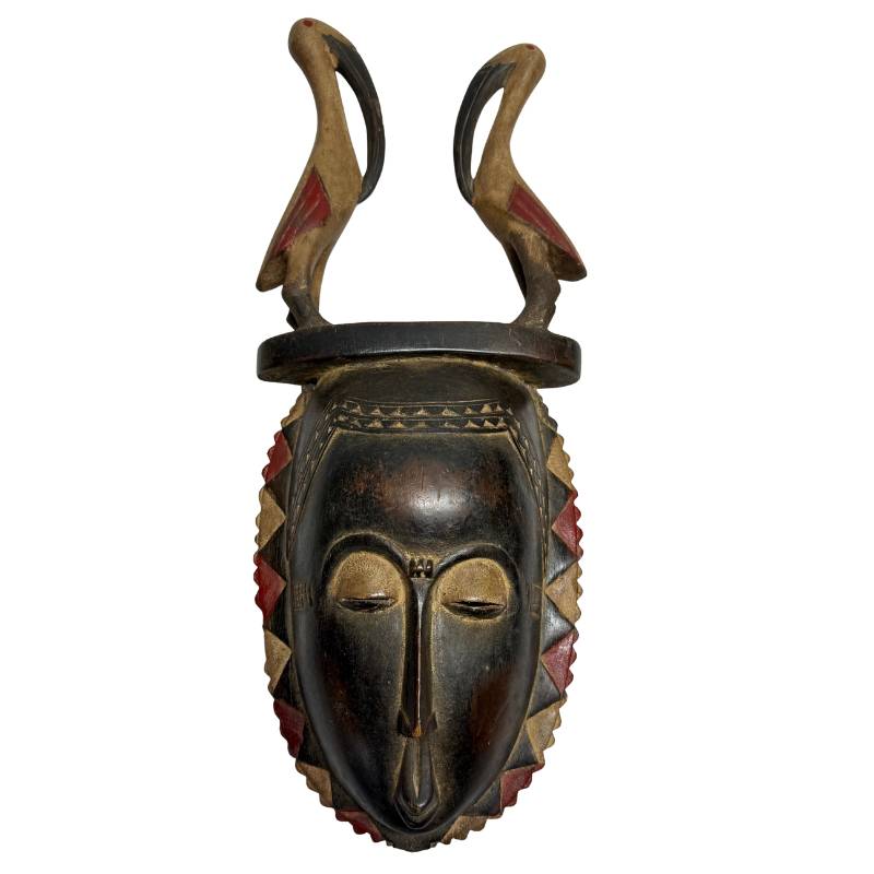 Hand-carved antique wooden Baule mask, 51 cm high, from Ivory Coast, with a double bird headdress and red pigments, perfect as exclusive wall art.