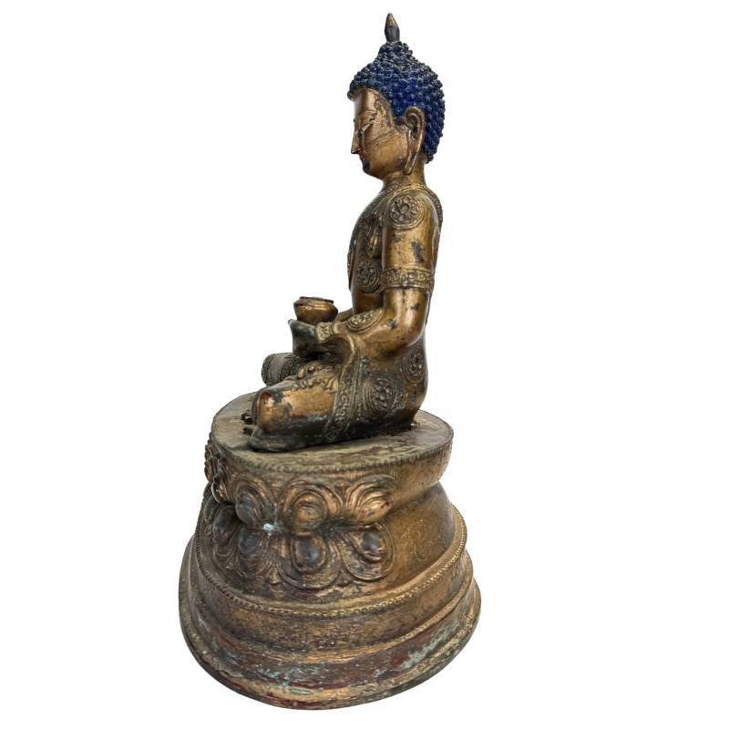 Large seated Buddha statue with gilded medicine bowl