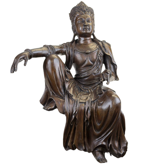 A historical bronze statue of Guanyin displayed in a museum setting.