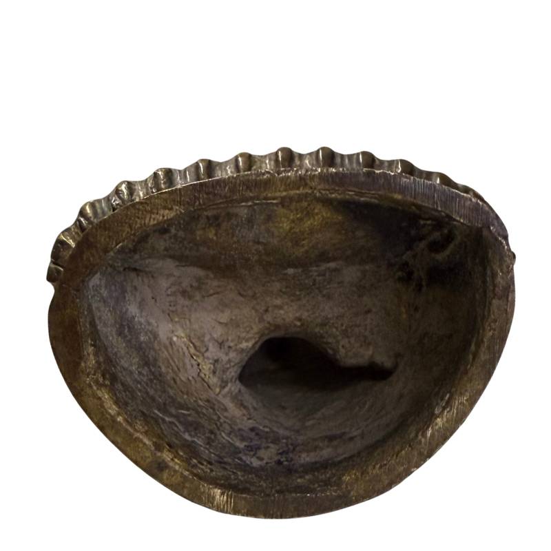 The underside of the sculpture revealing the raw casting process.