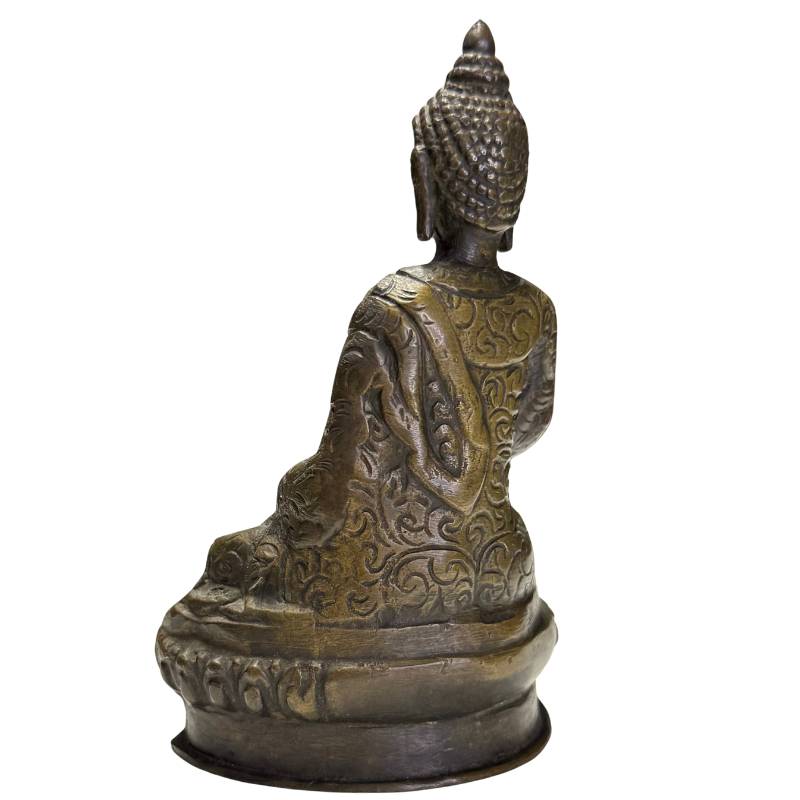 The serene facial expression of the Buddha with signs of age.