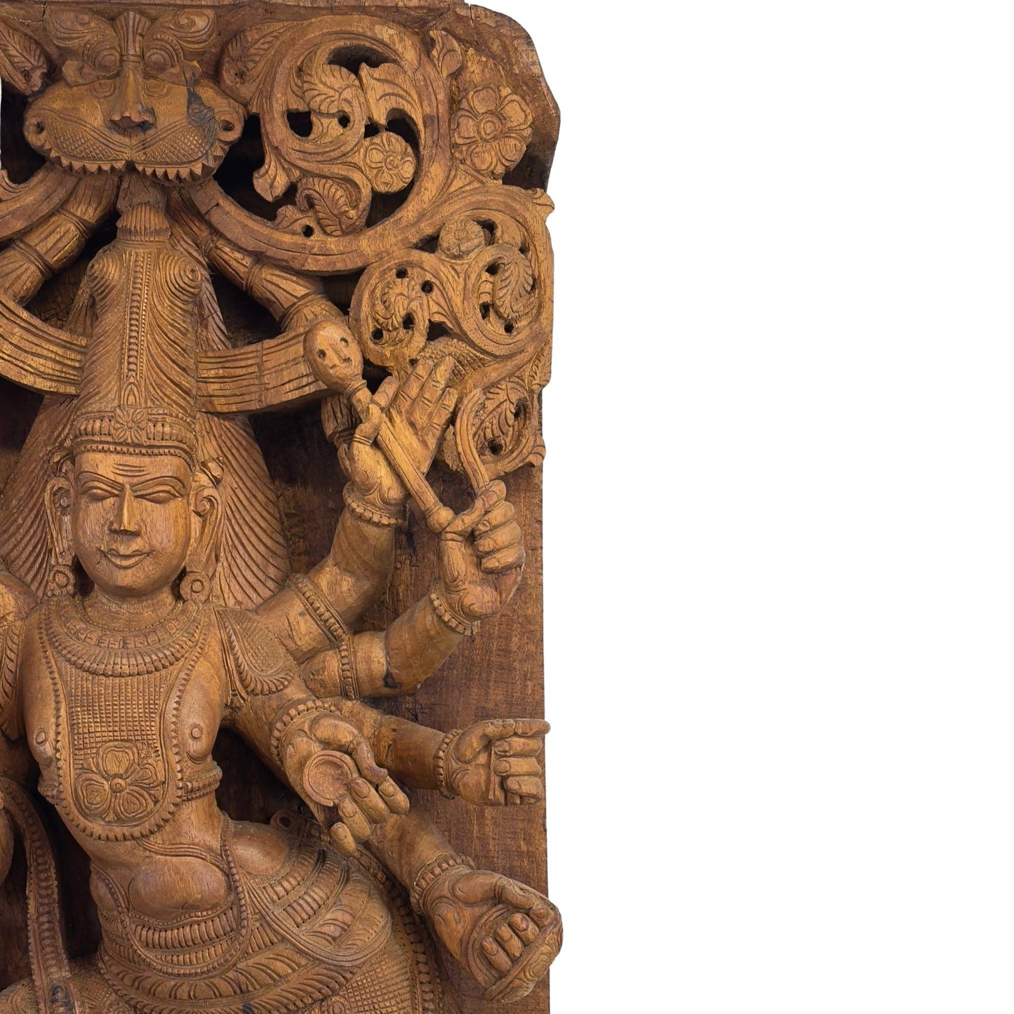 Detail of the top of the architectural panel with the protective Kirtimukha mask and openwork floral carving.