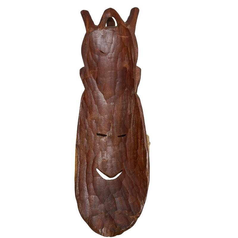 The deeply hollowed-out back of the wooden African mask with authentic hand adze marks and carving.