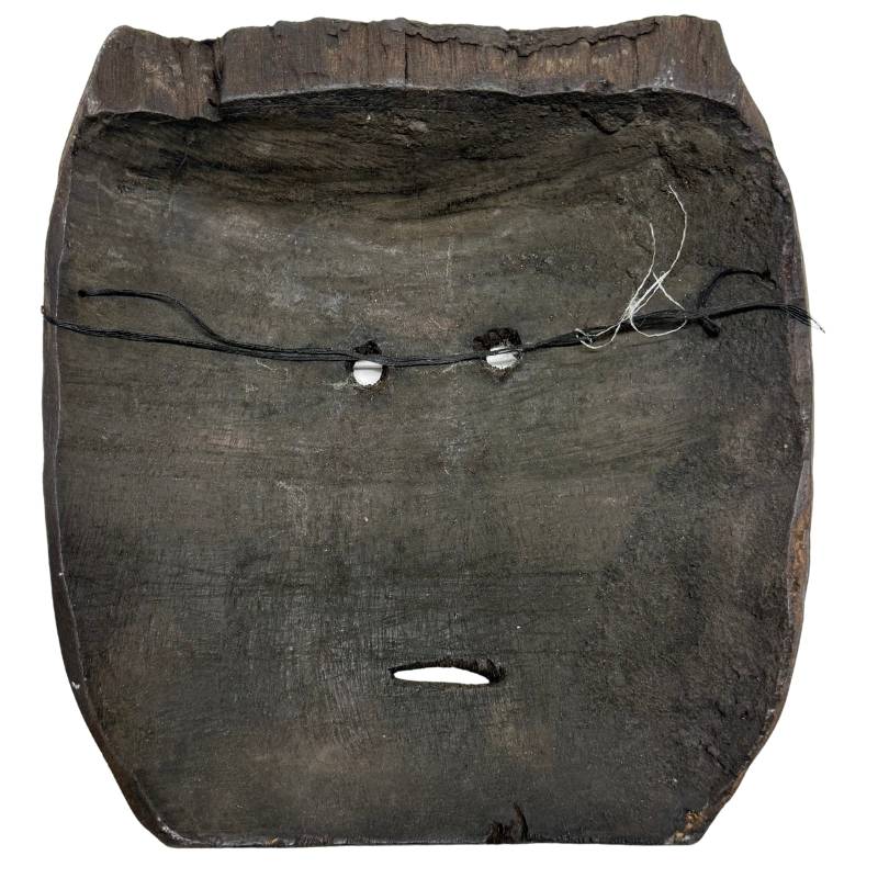 The hand-carved back of the wooden Congolese Pere mask with a verified greasy organic wear patina and adze marks.