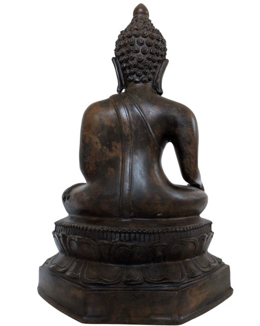 Back of a 40 cm high bronze Buddha statue with deep patina.