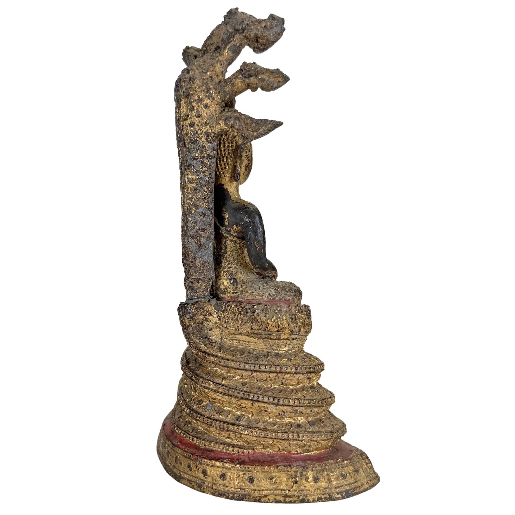 Back of antique Thai Naga Buddha with richly decorated snake structure