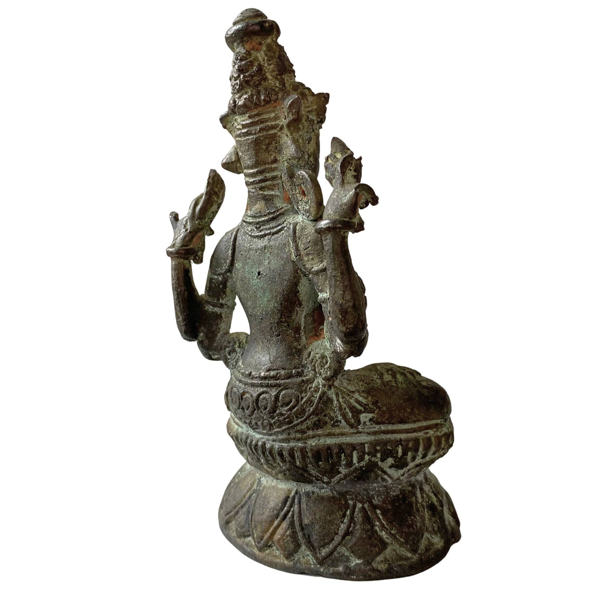 Back of an 18th-century Tibetan bronze statue with traces of the lost-wax casting method.