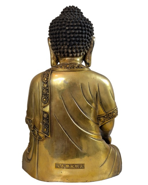 Back of the statue with visible natural aging of the bronze.