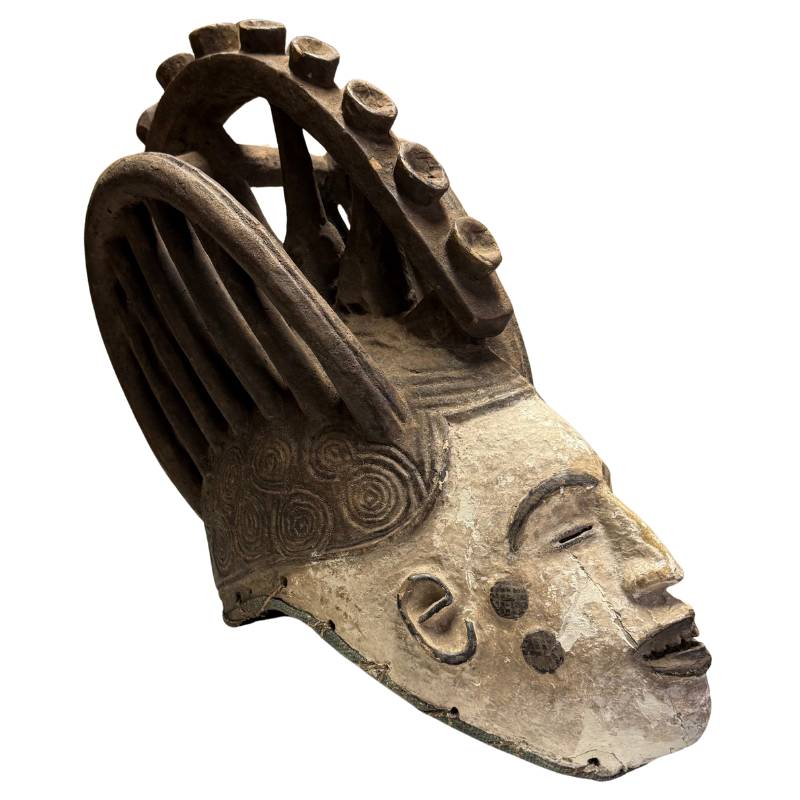 Antique African mask with high headdress, wooden ceremonial mask with spiral decoration and old patina