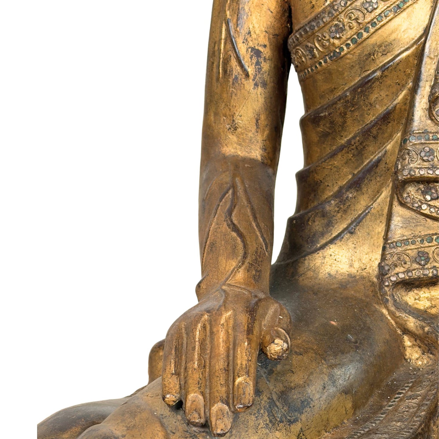 Forearm of the Burmese Moggallana statue with hyperrealistically carved veins and worn gold skin.