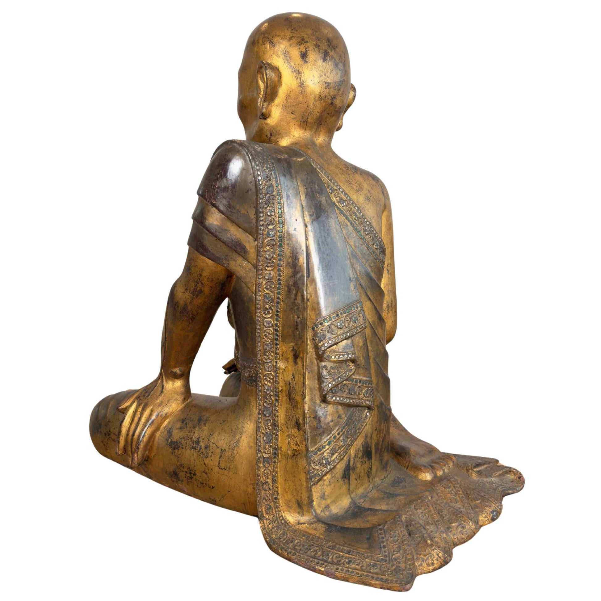 Burmese Moggallana monk of gilded wood with a decorated hmangazi mirror glass border on the civara reverse.