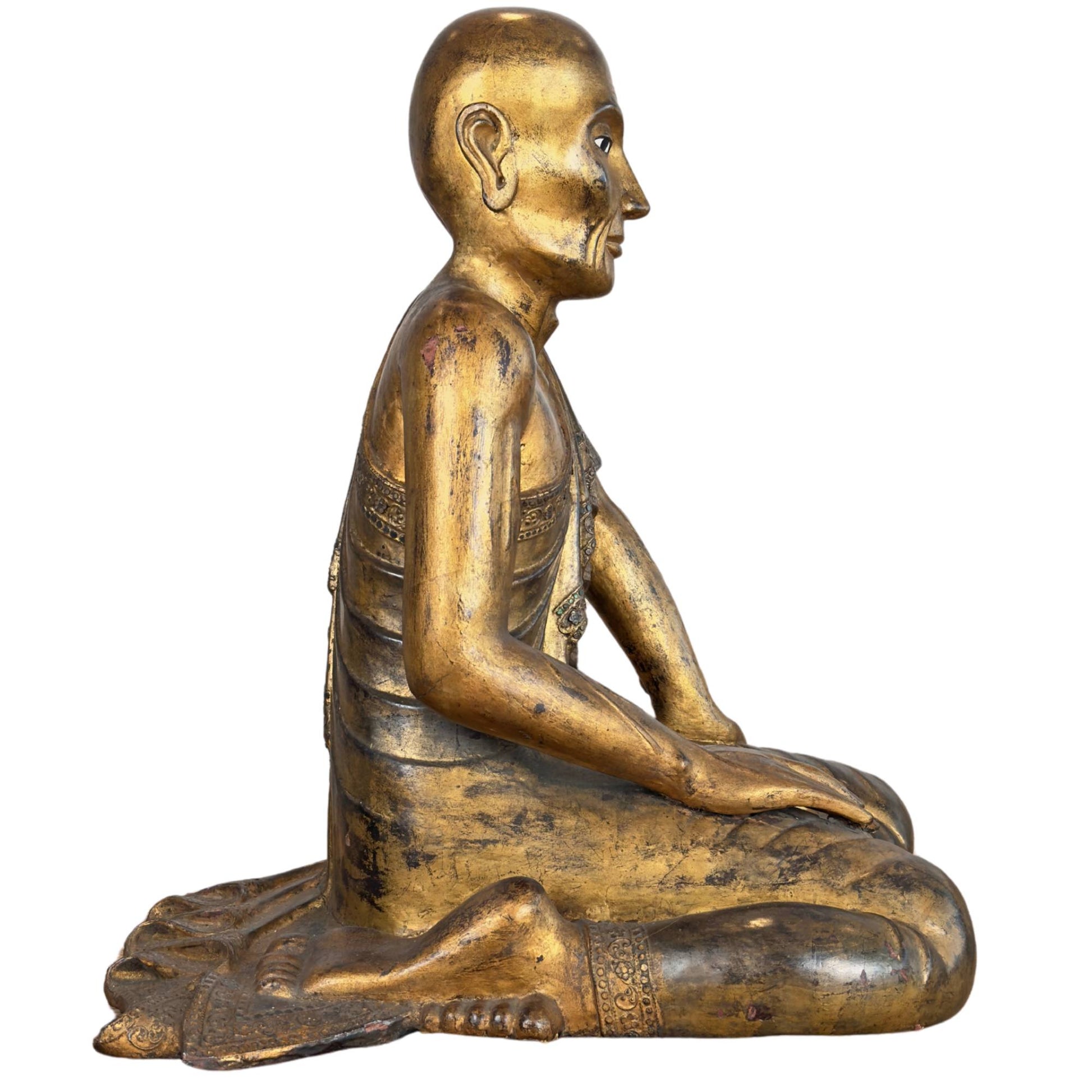 Burmese monk Sariputta of gilded wood with naturalistic drape of the civara and hmangazi mirror glass border.