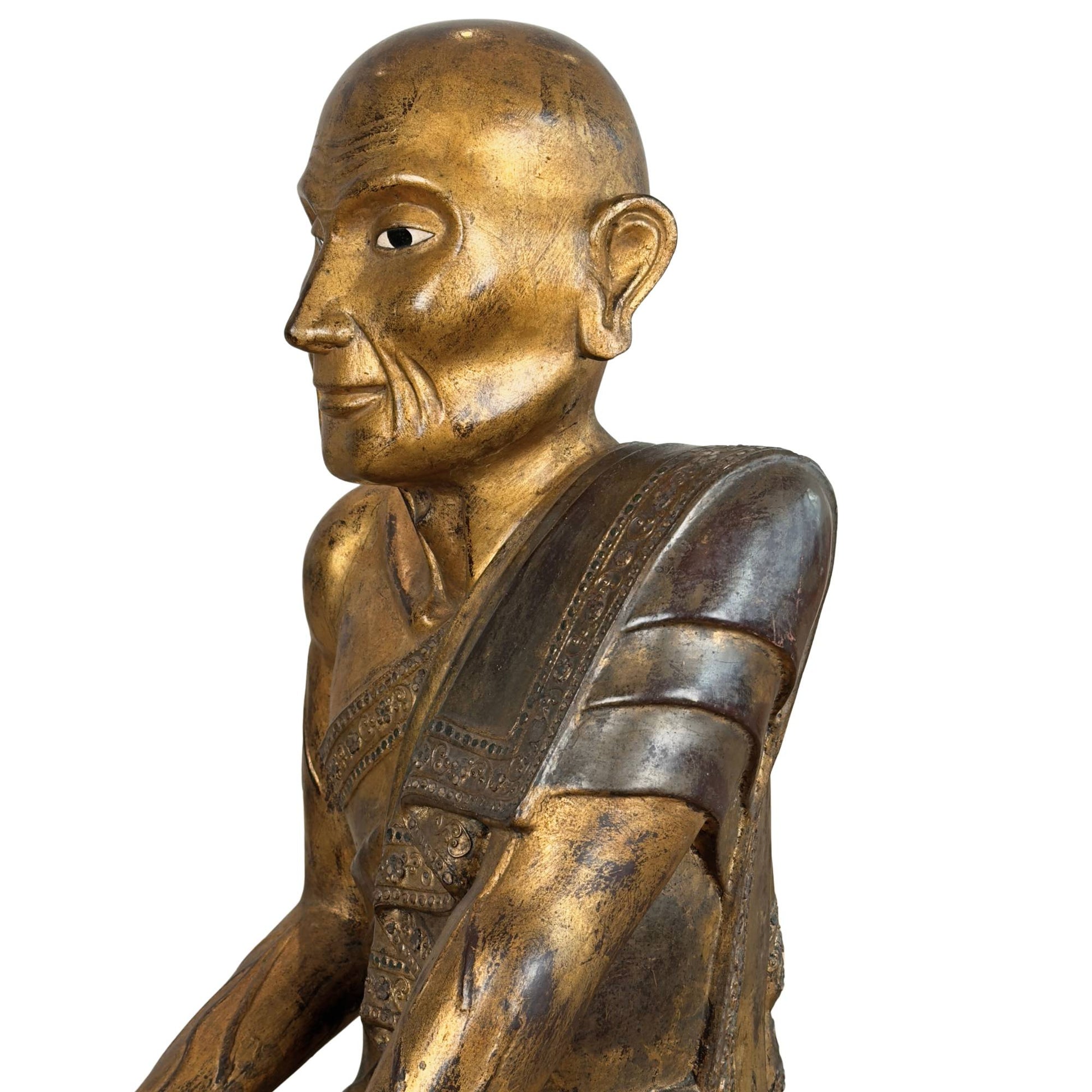 Burmese subfigure Sariputta in asymmetrical listening posture with the hand resting on the knee for dhamma contemplation.