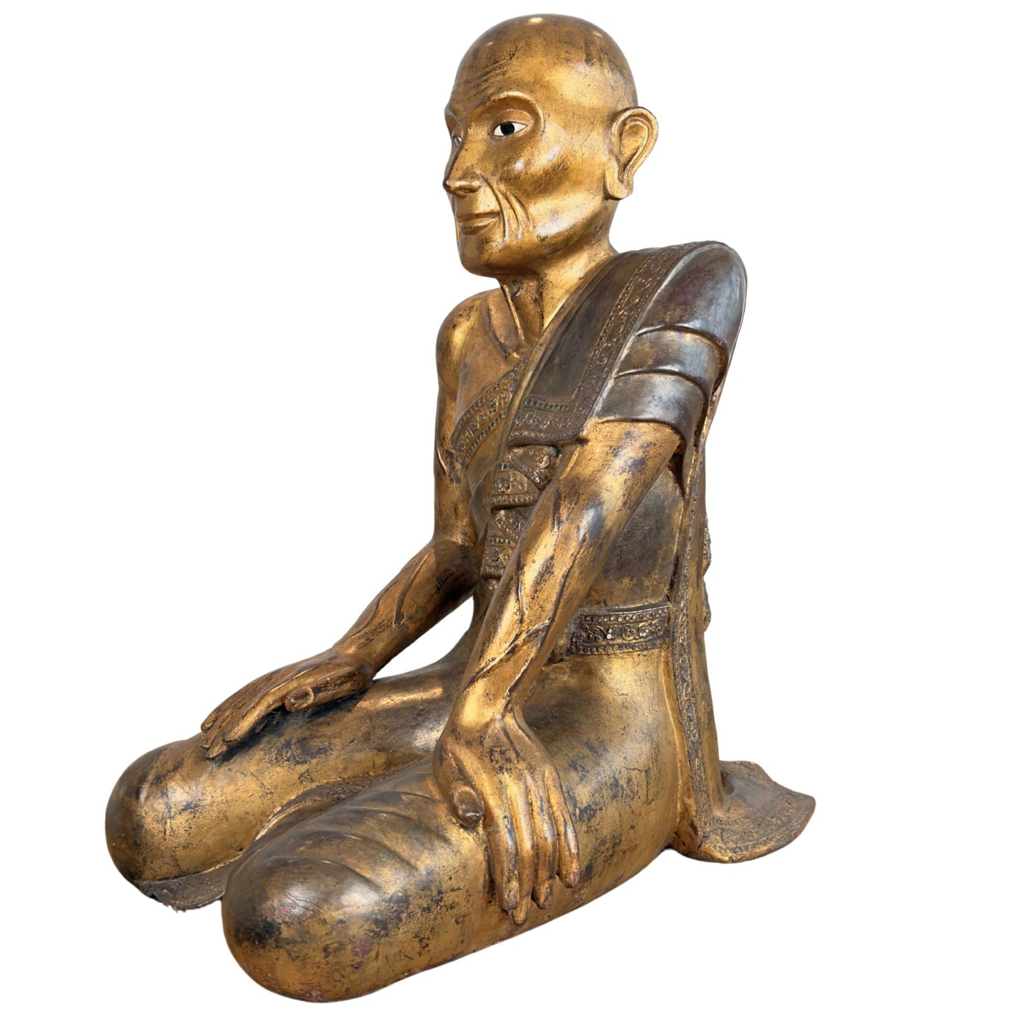 Burmese Sariputta monk of gilded wood in a seated position with dark Thit-si lacquer layers on the flank.