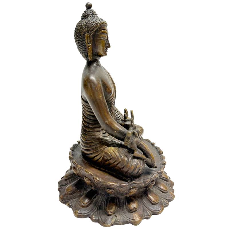 Antique bronze Buddha on traditional lotus throne
