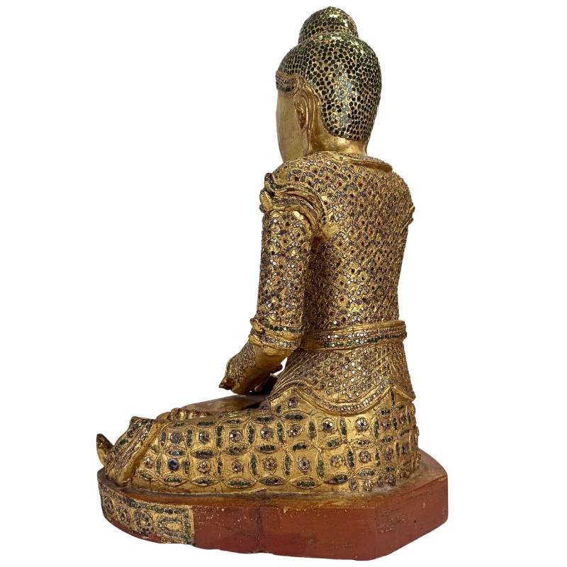 antique wooden Buddha statue with traditional glass decoration Myanmar