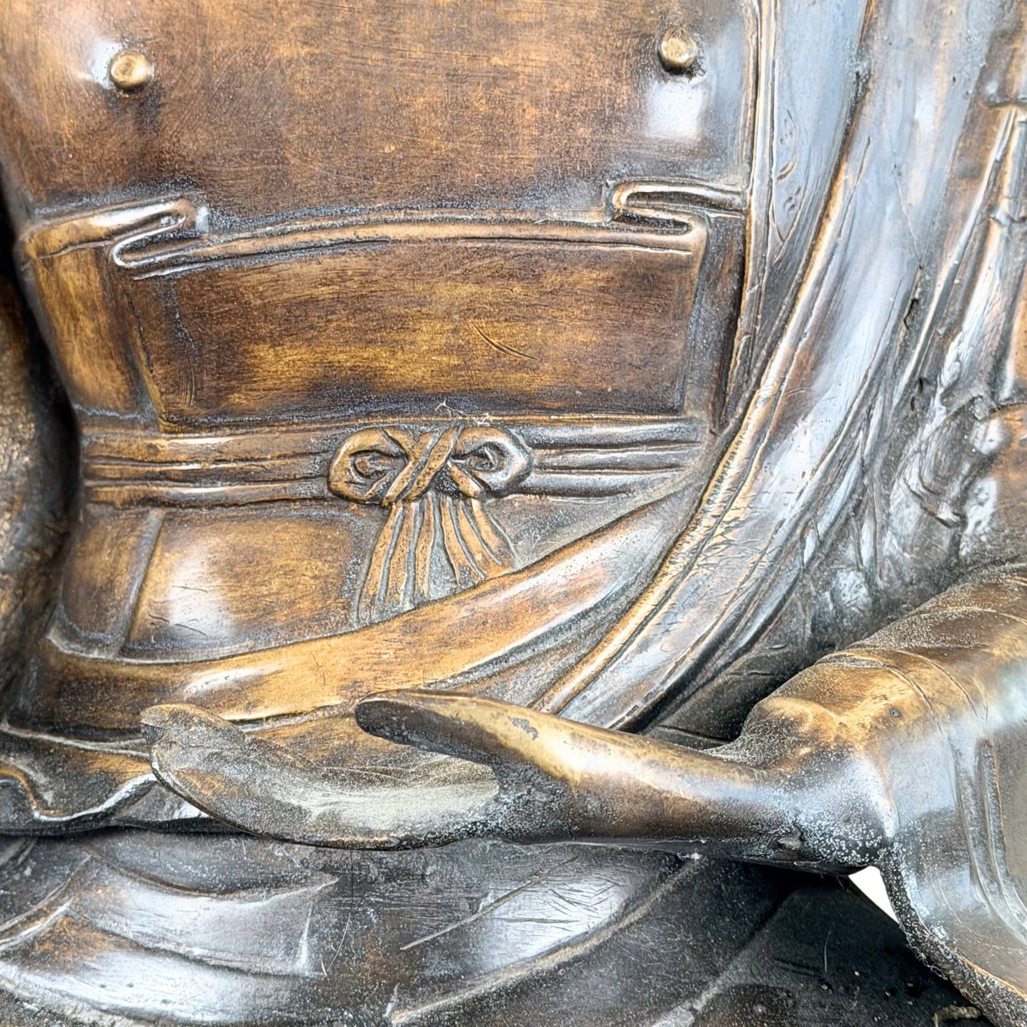 Antique Himalayan-style Buddha statue of heavy bronze with remnants of fire gilding and old surface wear.