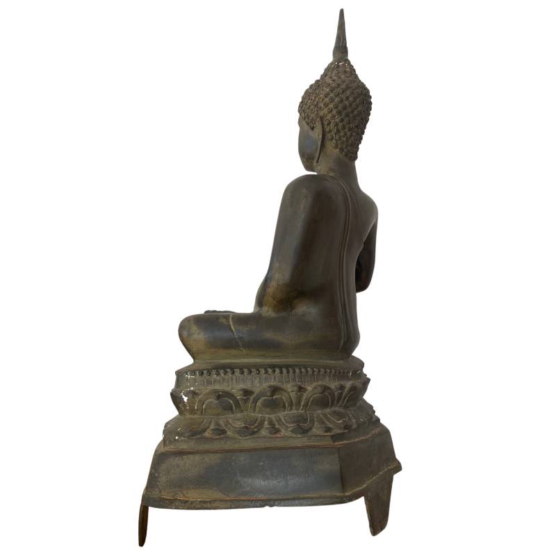 Antique bronze Buddha statue used in a temple context