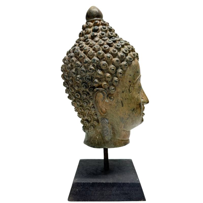 Antique bronze Buddha head with serene expression and closed eyes