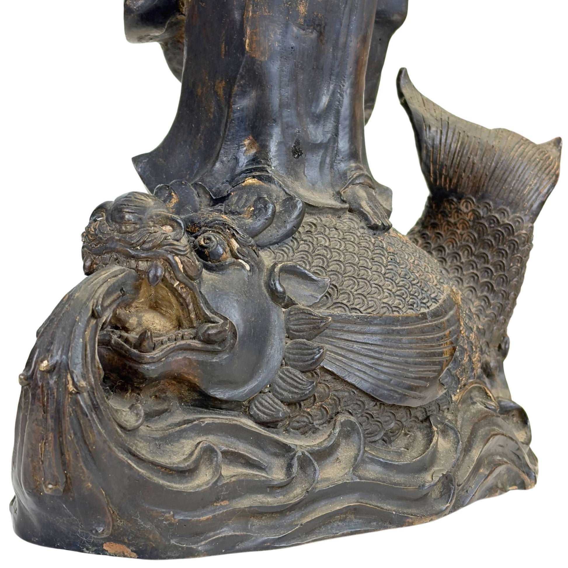 Antique bronze bodhisattva statue on a water dragon with richly detailed base and spiritual significance