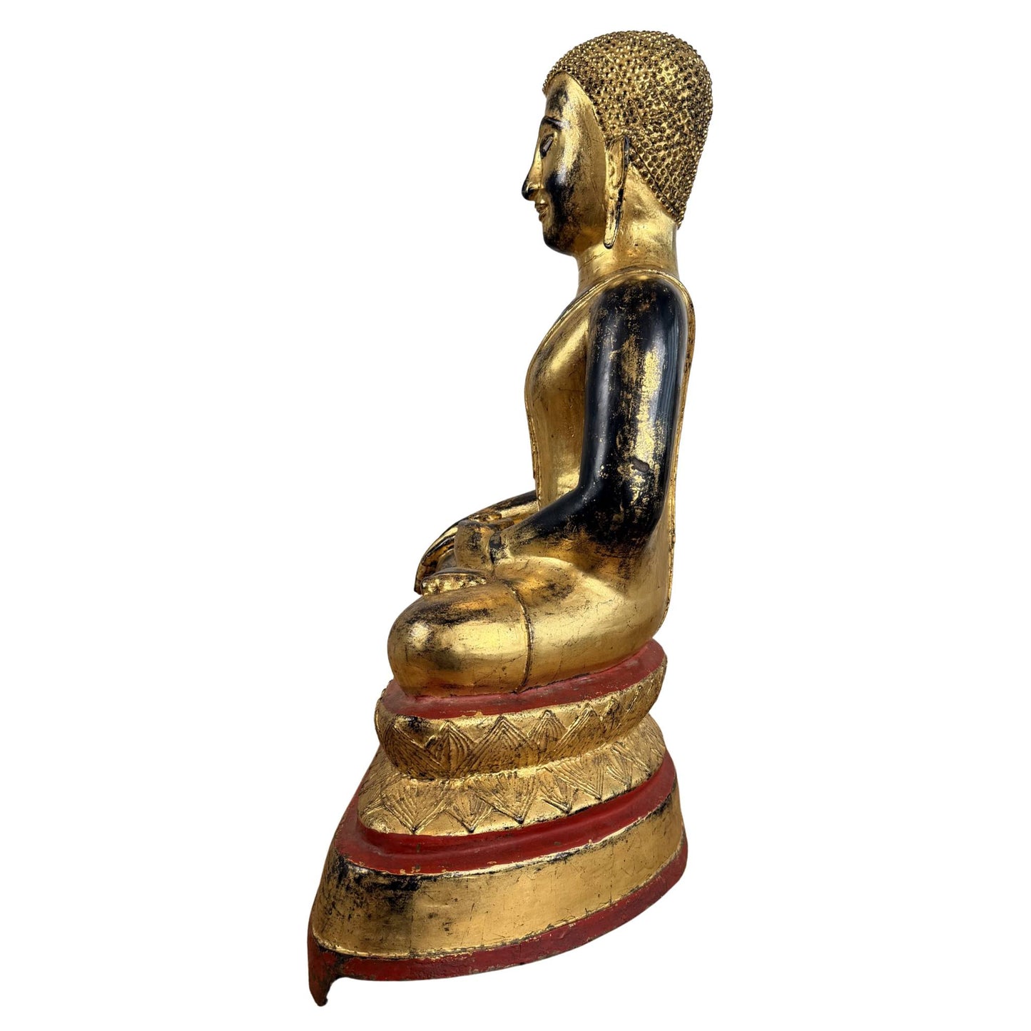 Antique bronze Buddha statue with inlaid eyes, gold-colored fire gilding, and a serene facial expression