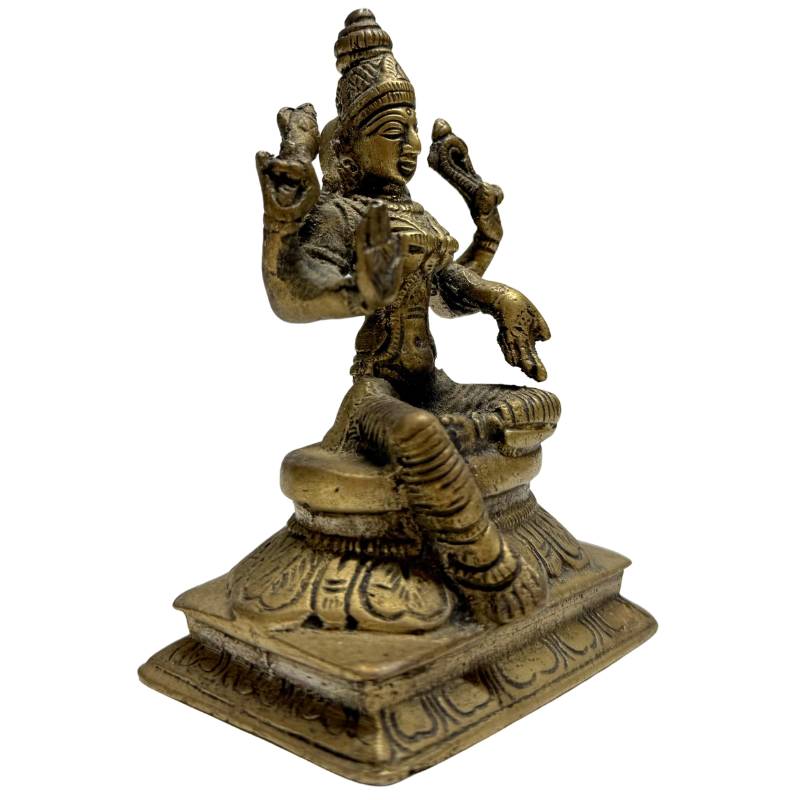Bronze statue of Lakshmi with four arms on a lotus pedestal

