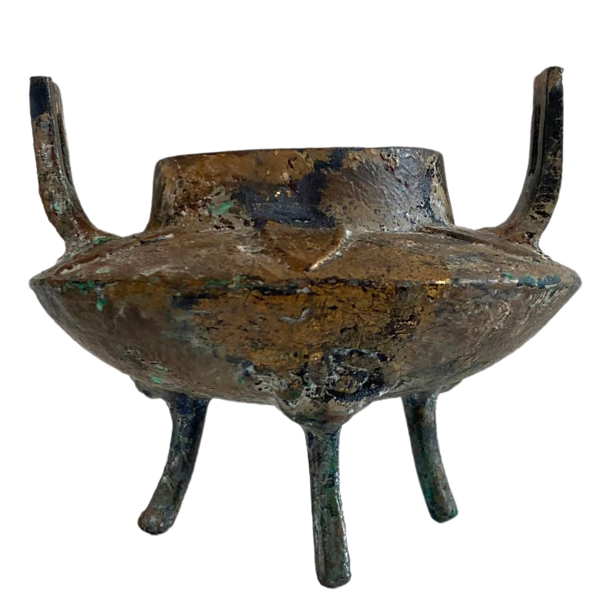 Front view of an authentic Qing Dynasty Ding incense burner with Taotie masks.
