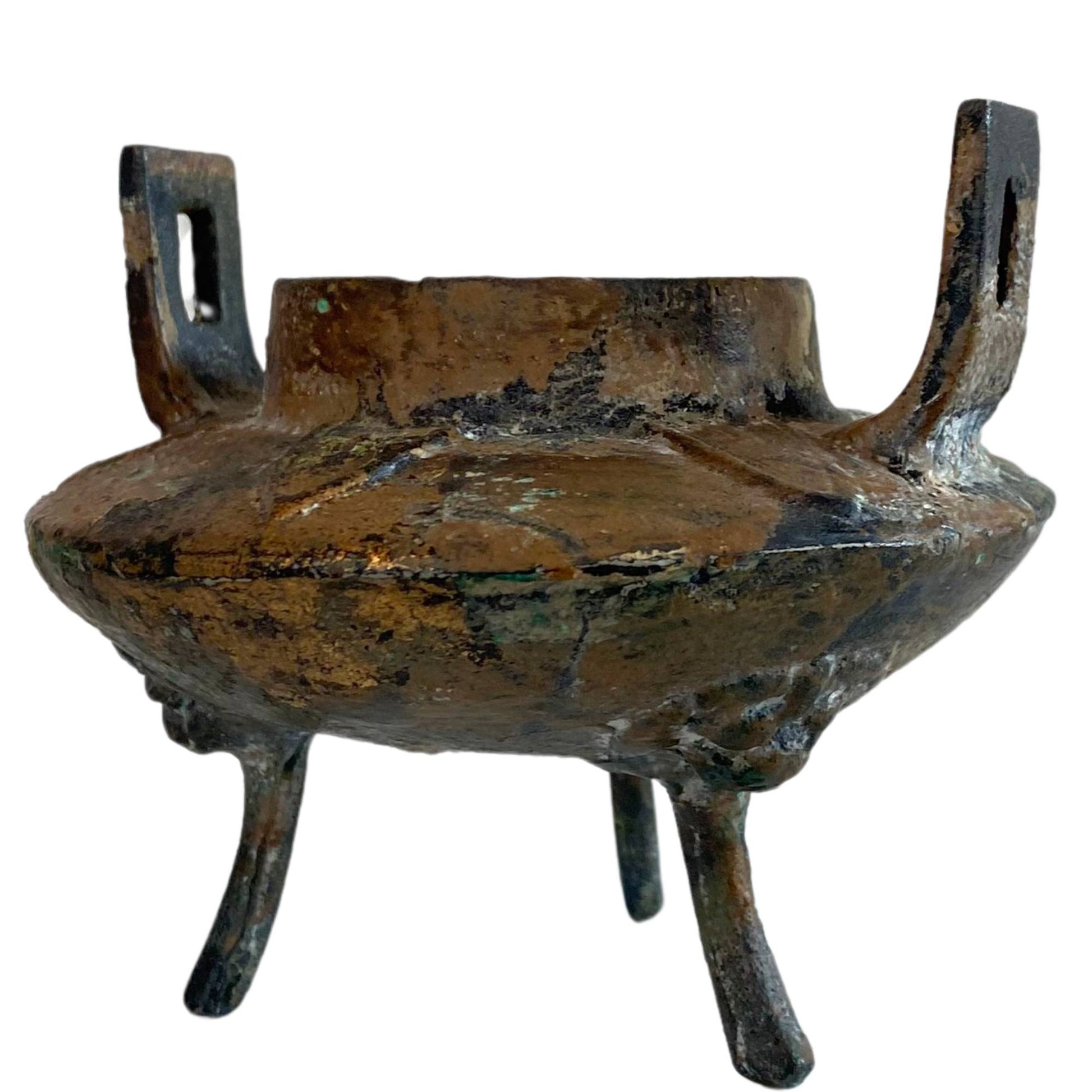 The rear view shows the black magnetite patina and soot on the cast iron surface.