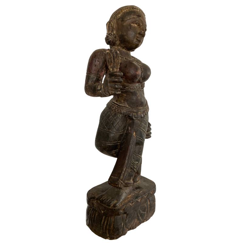 Detail of wooden Lakshmi statue from Nepal with clear wood grain and aging