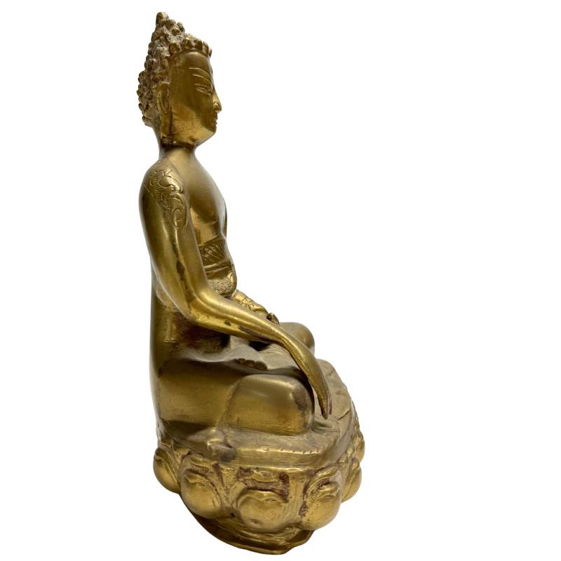Detailed shot of the upper body of a Tibetan bronze Buddha, focusing on the serene facial expression.