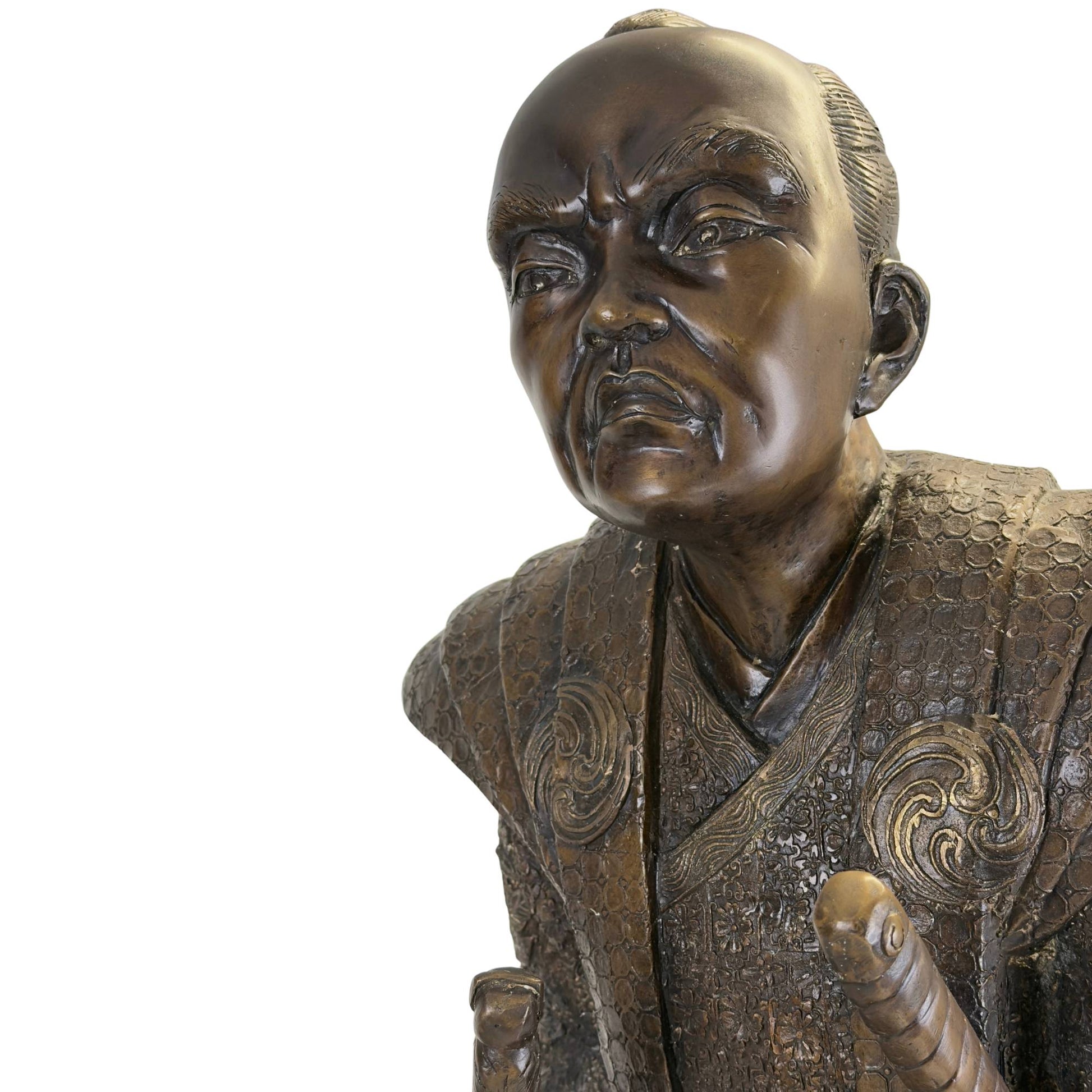 Powerful macro shot of the Daimyo's face with the intense, furrowed brow and the smooth golden-brown patina on the cheekbones.