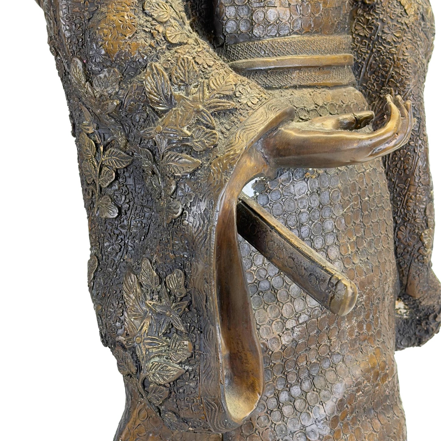 Macro shot of the open sleeve showing the fine relief pattern with floral motifs and the hilt of the Wakizashi sword.