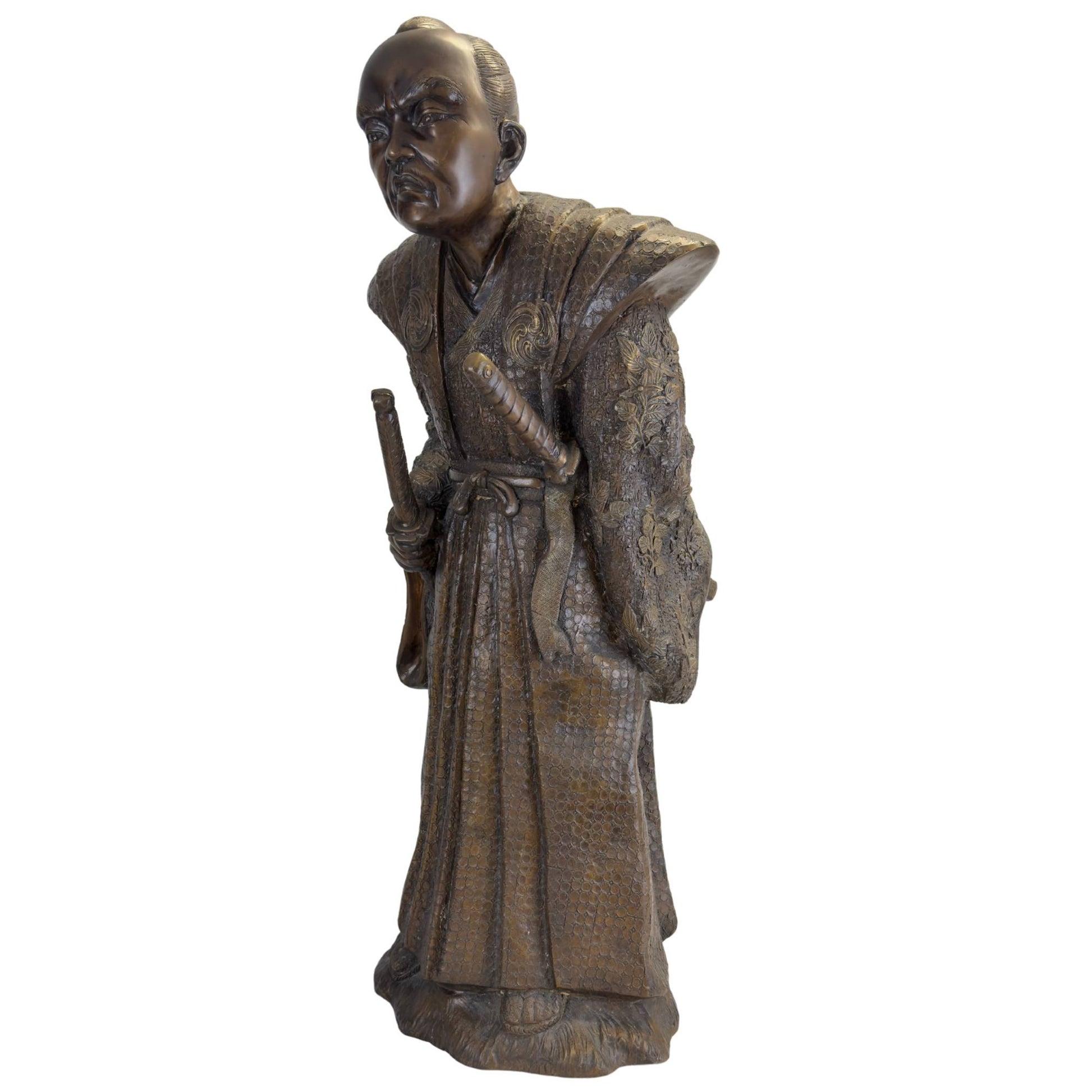Three-quarter frontal view of the bronze Samurai in his ceremonial war stance with the Daisho swords prominently visible.