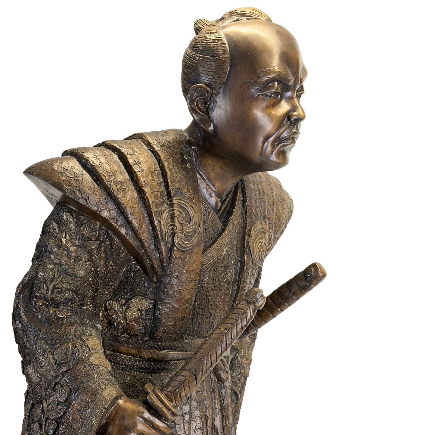 Profile view of the Japanese bronze sculpture showing the characteristic dynamic pose and deep patina.