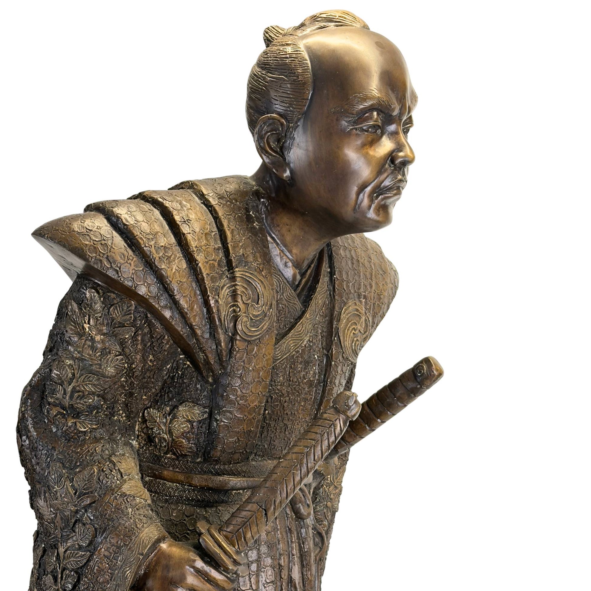 Profile view of the Japanese bronze sculpture showing the characteristic dynamic pose and deep patina.