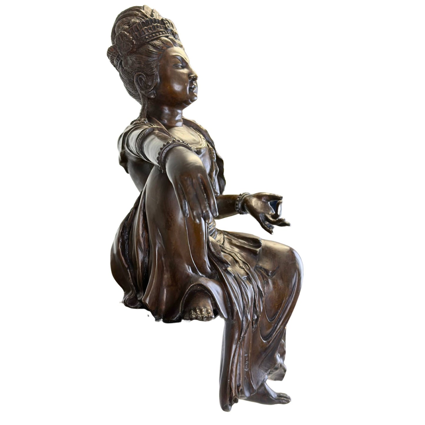 Close-up of the serene face and the detailed ceremonial tiara of the bronze Guanyin Bodhisattva.
