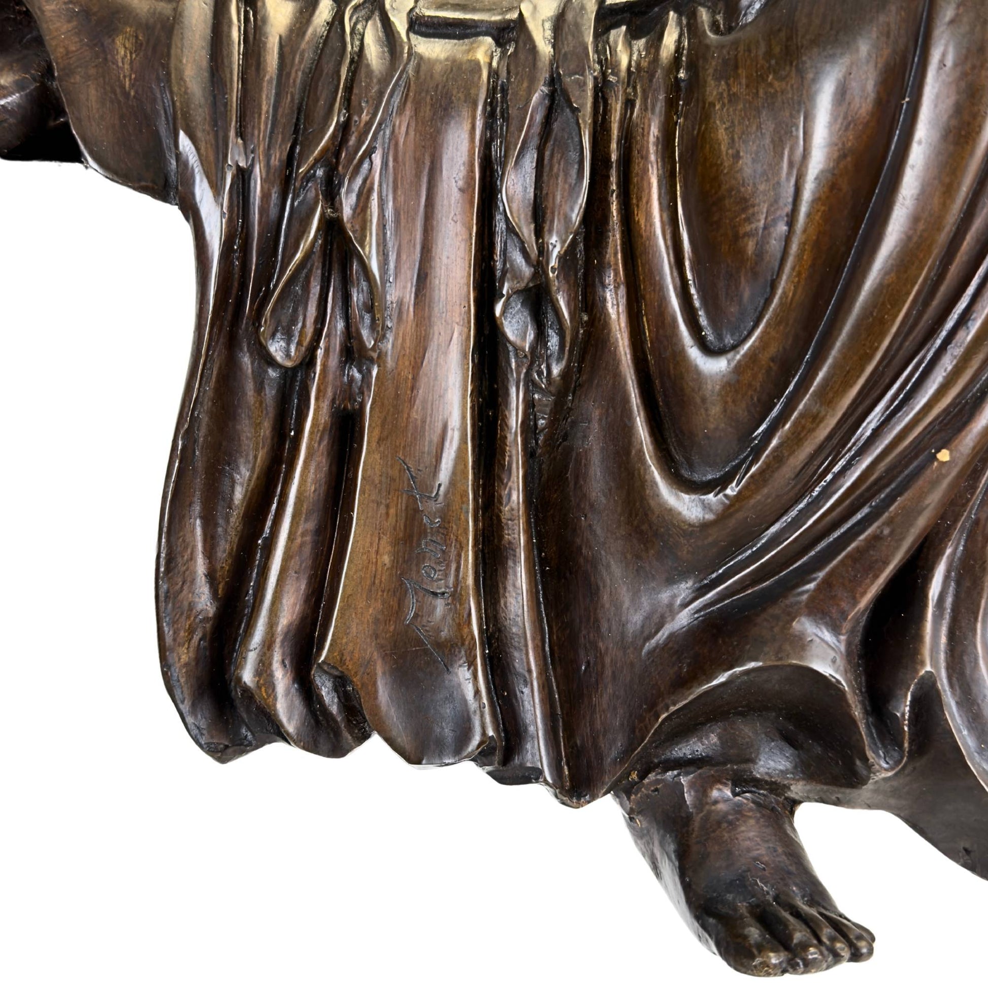 Detailed macro shot of the cast-in, handwritten French foundry signature Monet in the flowing drapery of the bronze robe.