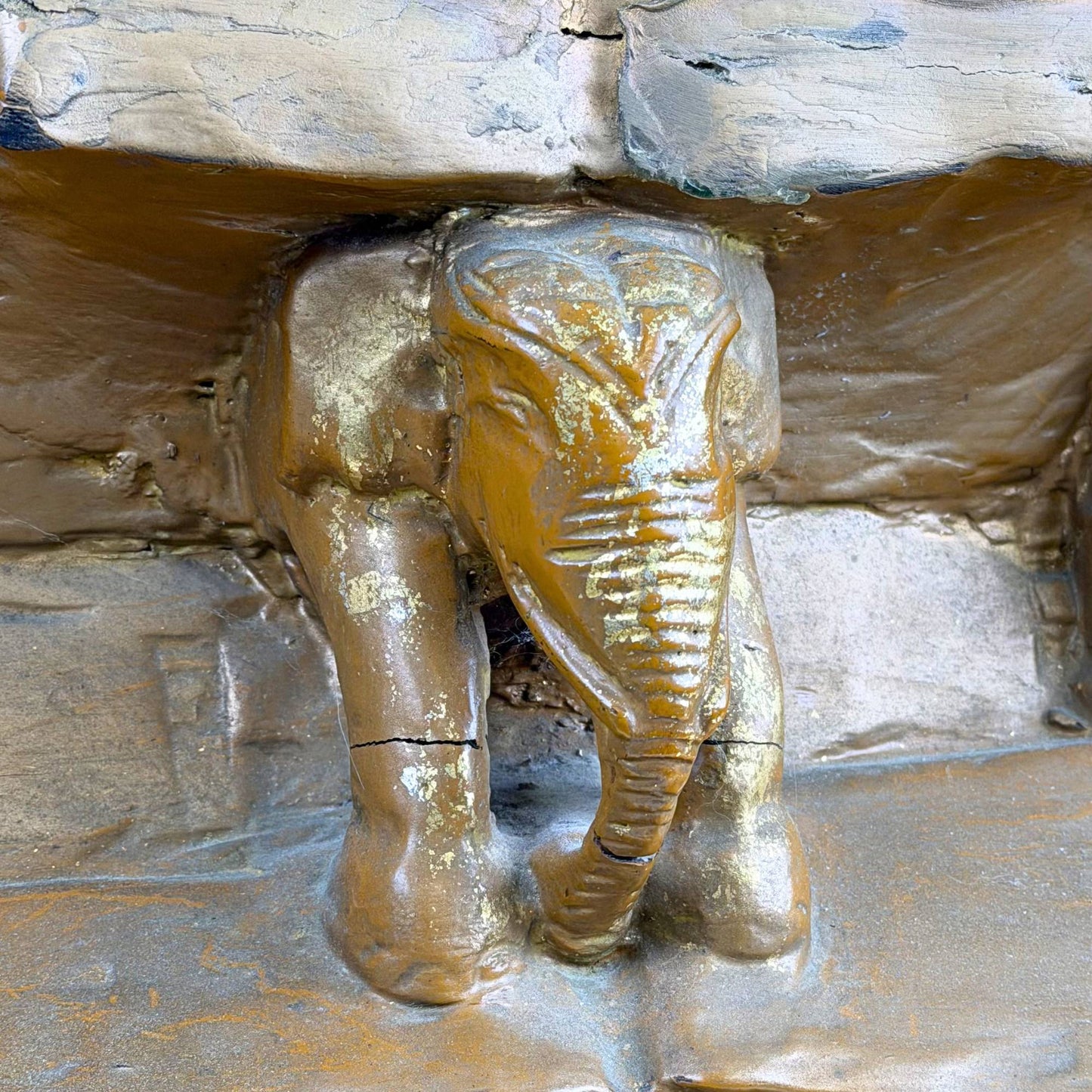 Antique Burmese Buddha with inlaid eyes, gold details, and wooden throne base with elephants