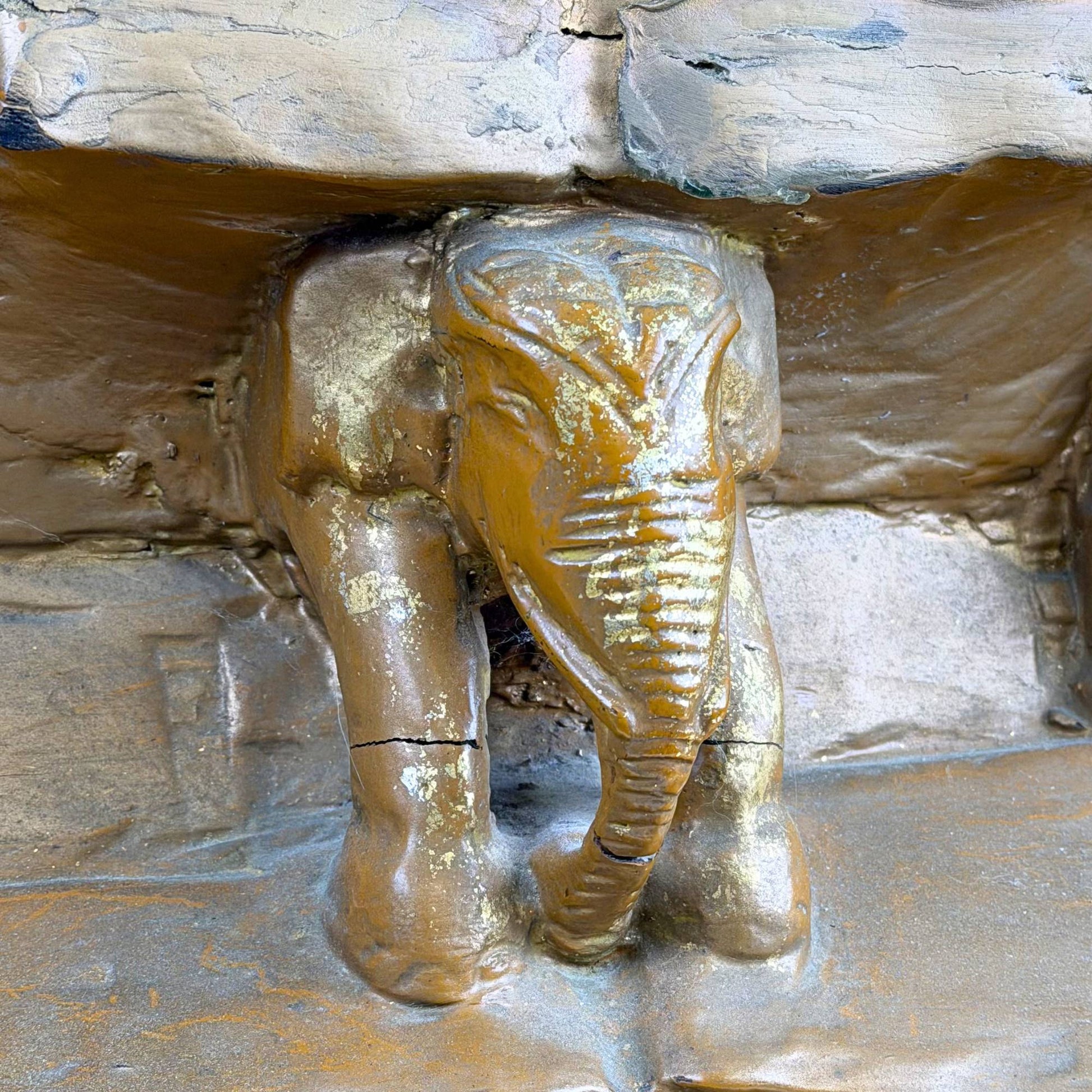 Antique Burmese Buddha with inlaid eyes, gold details, and wooden throne base with elephants