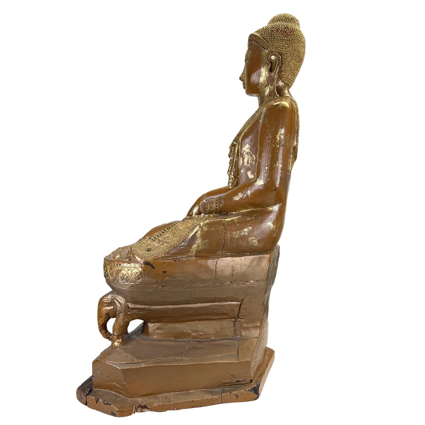 Side profile of an antique Burmese Buddha with gold lacquer, long earlobe, and serene facial expression.