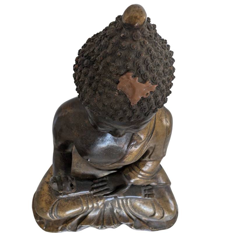 Detail of oxidation and patina on an antique Chinese bronze Buddha statue